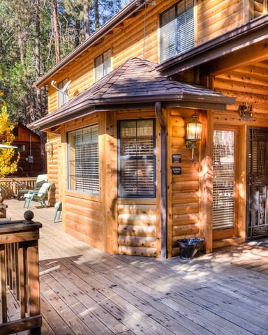 Cedar Lodge exterior with warm log cabin facade and autumn foliage