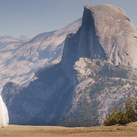 Bride and groom at Glacier Point with Half Dome behind